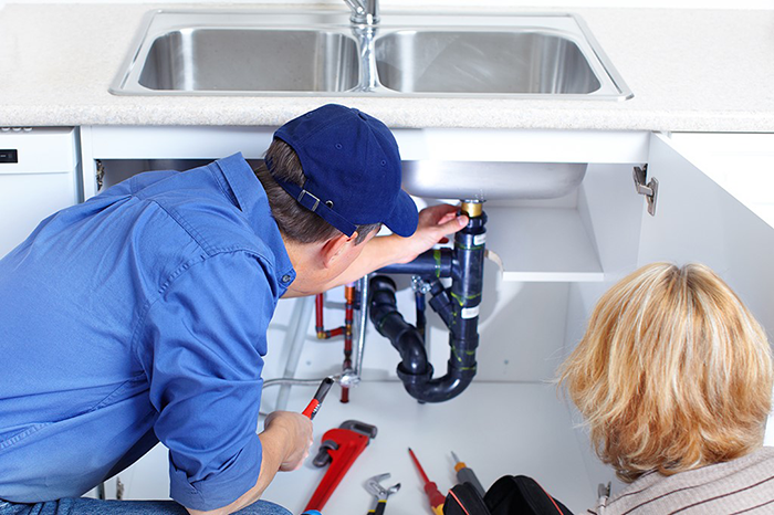 A technician performing advanced plumbing tasks, such as gas line detection, hydrojetting, and trenchless sewer repair. The image highlights services from Water Heater Repair McKinney, TX, including septic tank maintenance, pipe repiping with copper and PEX, and emergency repairs for slab leaks and burst pipes.