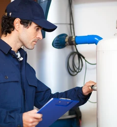 technician repairing a hot water heater